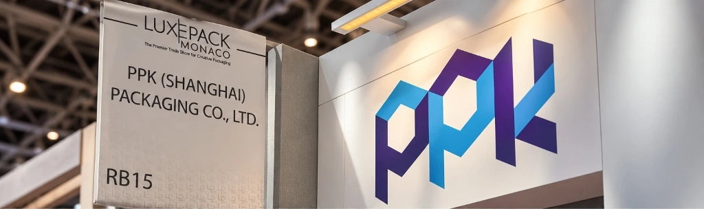 PPK Booth RB15 at LUXE PACK Monaco 2026 with hanging sign and 3D glowing logo